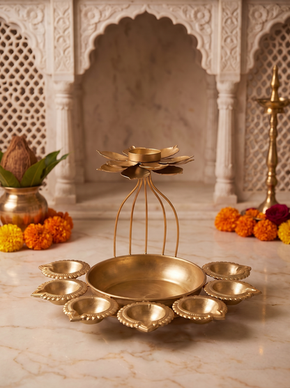 Gold wire-cage lotus diya bowl with 7 diya cups, front view in a festive mandir setting