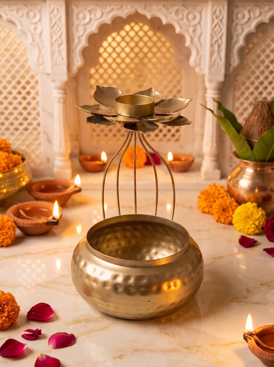 Gold hammered urli pot with wire cage and lotus tealight top, front view in a festive mandir setting