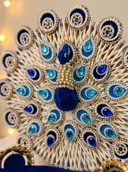 Close-up detail of pearl peacock backrest and gold trim on royal blue velvet singhasan