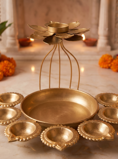 Close-up detail of hammered gold bowl and wire-cage lotus on Diwali diya set