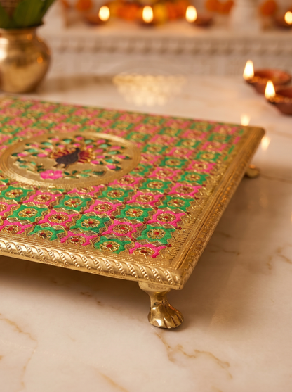 Close-up detail of pink and green checkered brocade on square puja chowki
