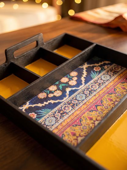 Close-up detail of brocade-lined compartments in black lacquer sectioned tray