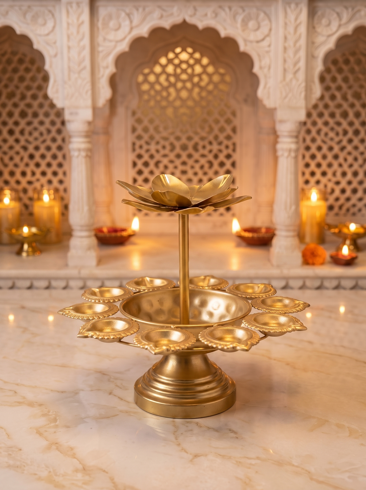 Close-up detail of lotus diya cups on gold two-tier pedestal tealight stand