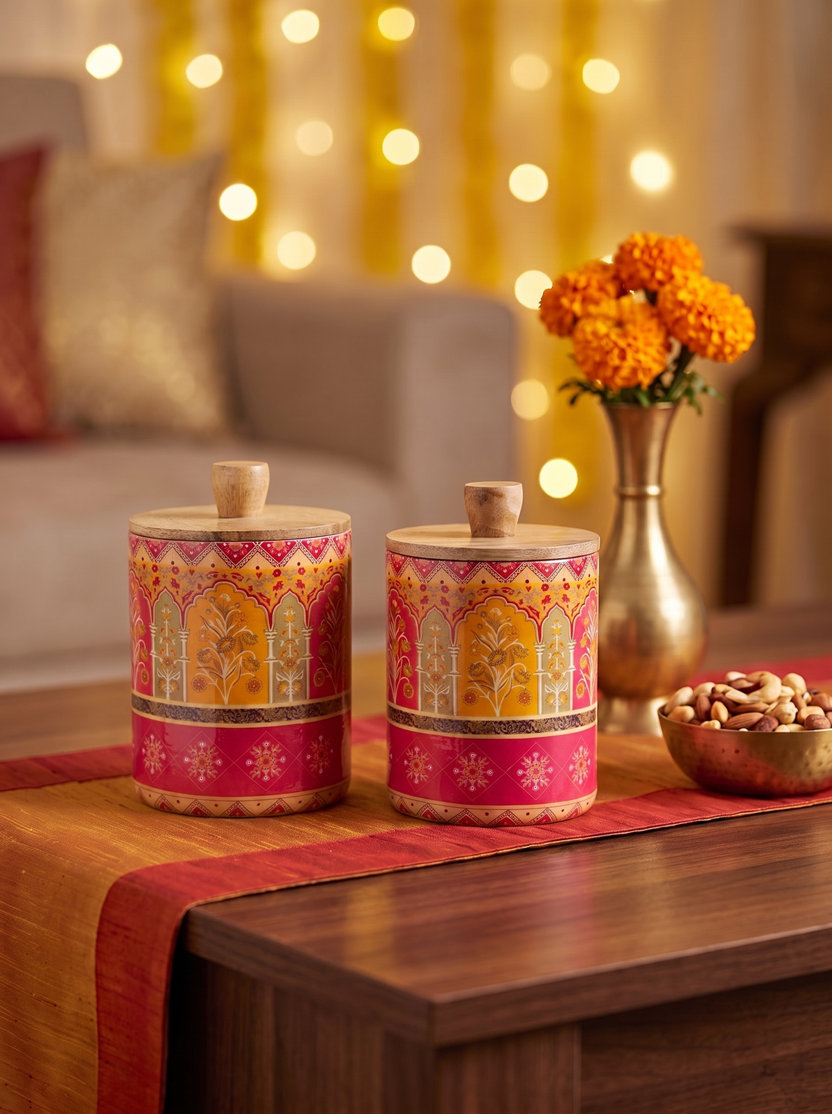 Pink and saffron Mughal arch print wooden canisters, angled view