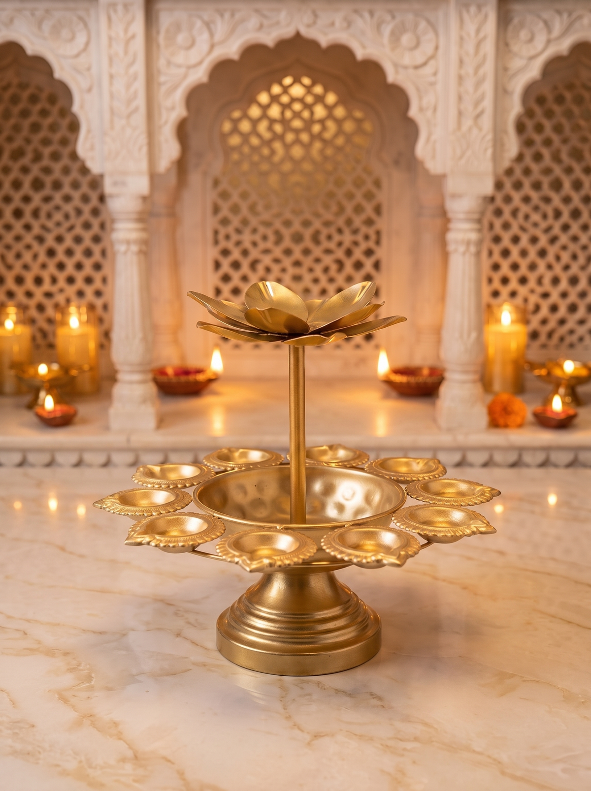 Gold lotus two-tier diya stand, angled view with marigolds