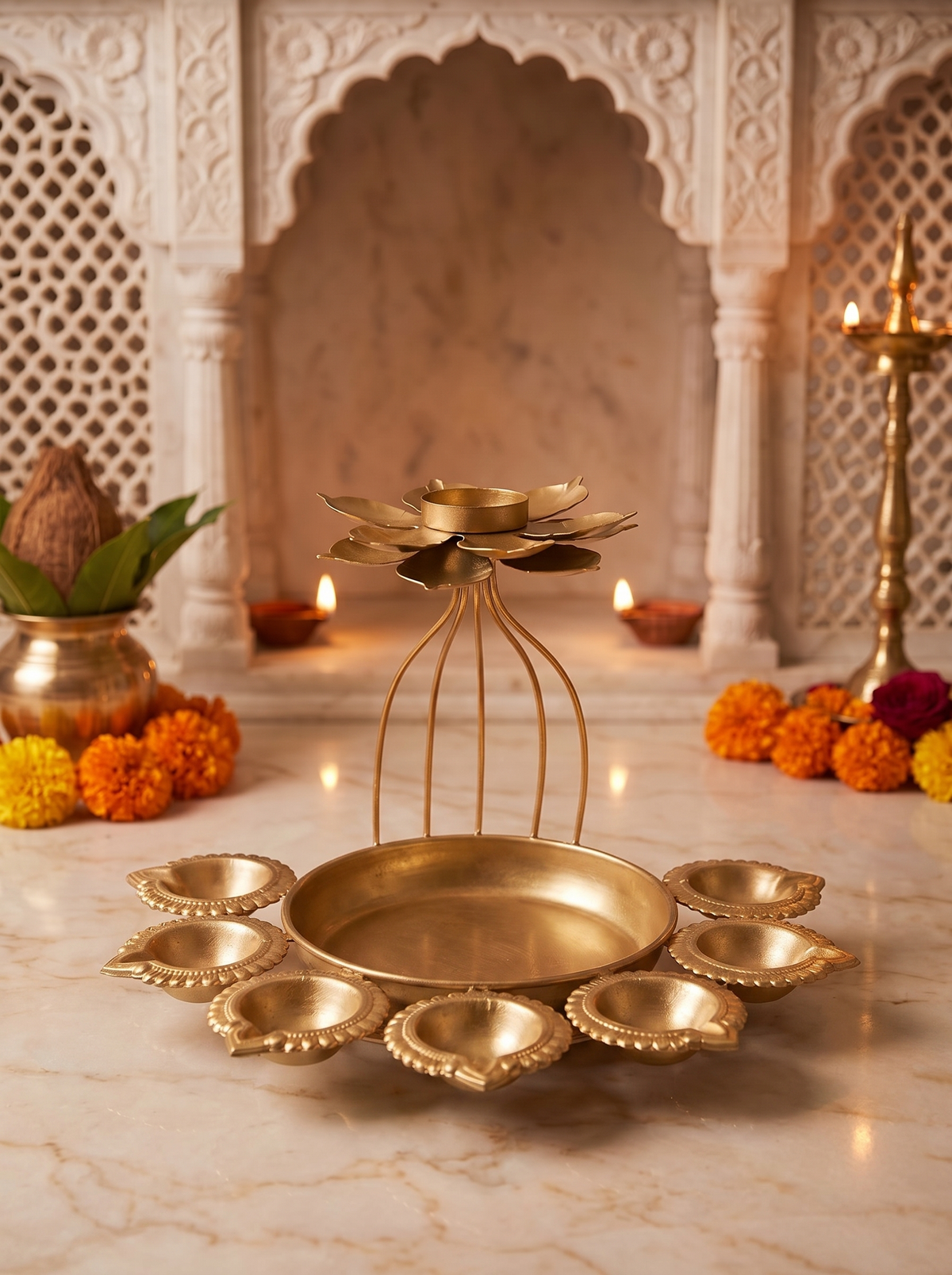 Gold wire-cage lotus diya set with seven cups, angled view with marigolds