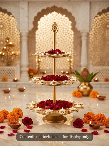 Gold 3-tier lotus diya stand styled with lit tealights for Diwali