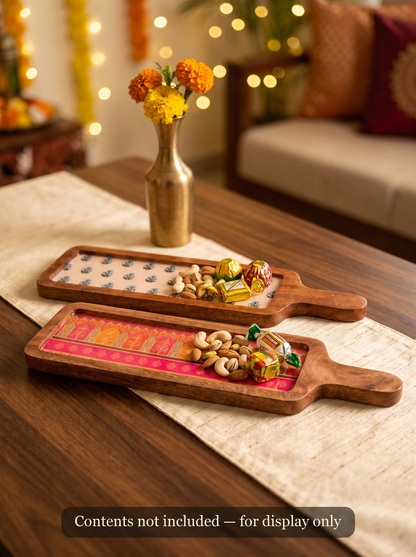 Wooden serving board styled with cheese and snacks for a Diwali party