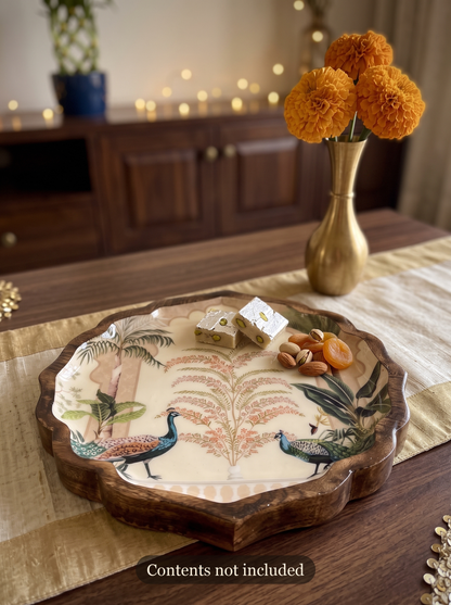 Peacock print scalloped wooden platter styled and filled with sweets for Diwali