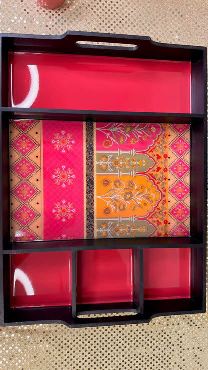 Black lacquer sectioned dry fruit tray with pink and orange brocade panels, top view