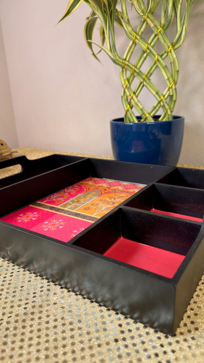 Black lacquer serving tray showing five brocade-lined compartments for mithai and dry fruits