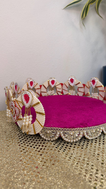 Close-up of pearl and kundan scalloped rim on magenta velvet decorative tray