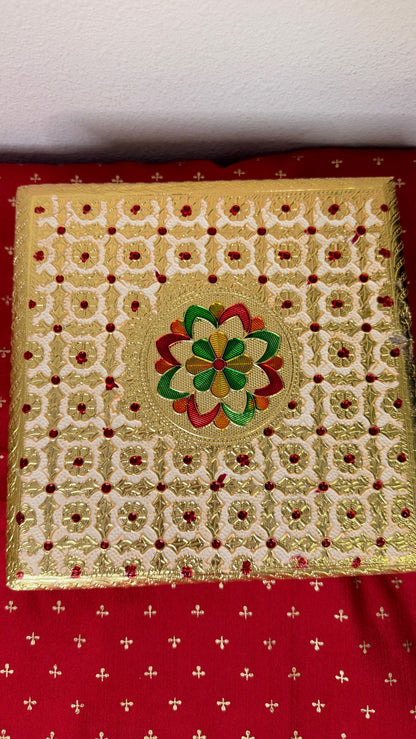 Top view of gold brocade puja chowki with maroon dot pattern for Ganesh and Diwali puja