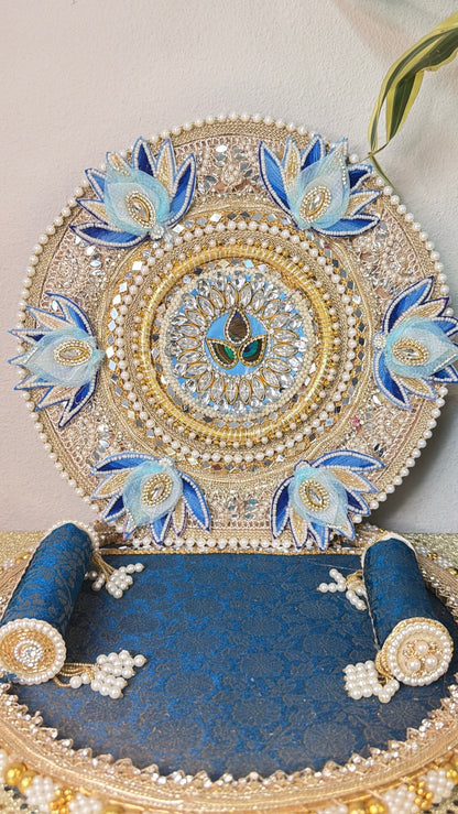 Close-up of silver zari embroidery and blue lotus buds on Laddu Gopal singhasan backrest