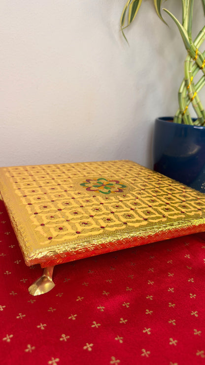 Gold brocade puja chowki showing decorative gold feet