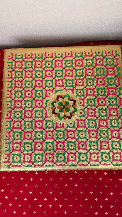 Top view of pink and green checkered brocade bajot chowki