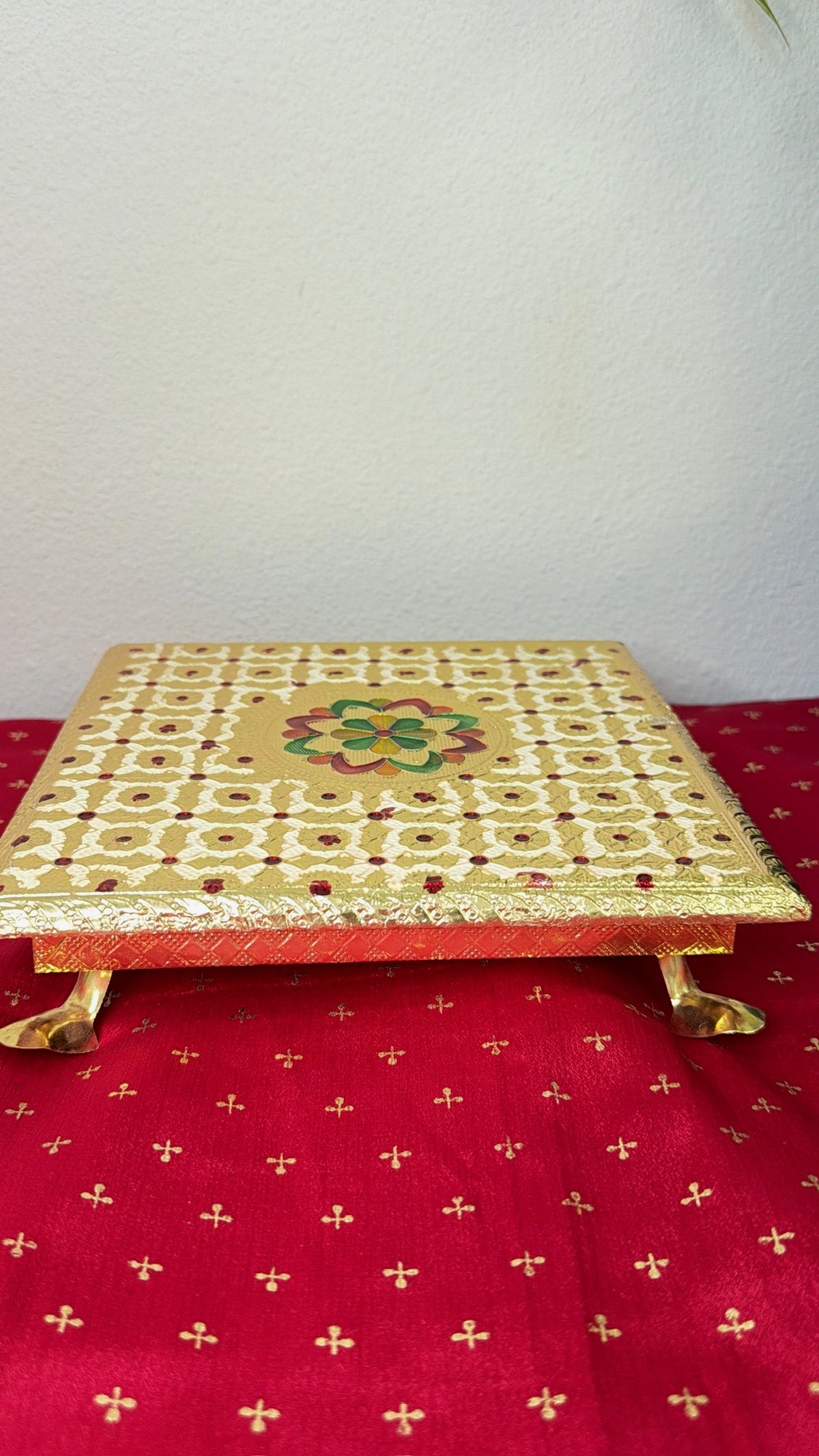 Gold brocade square puja chowki bajot with maroon dot and floral centre and gold feet