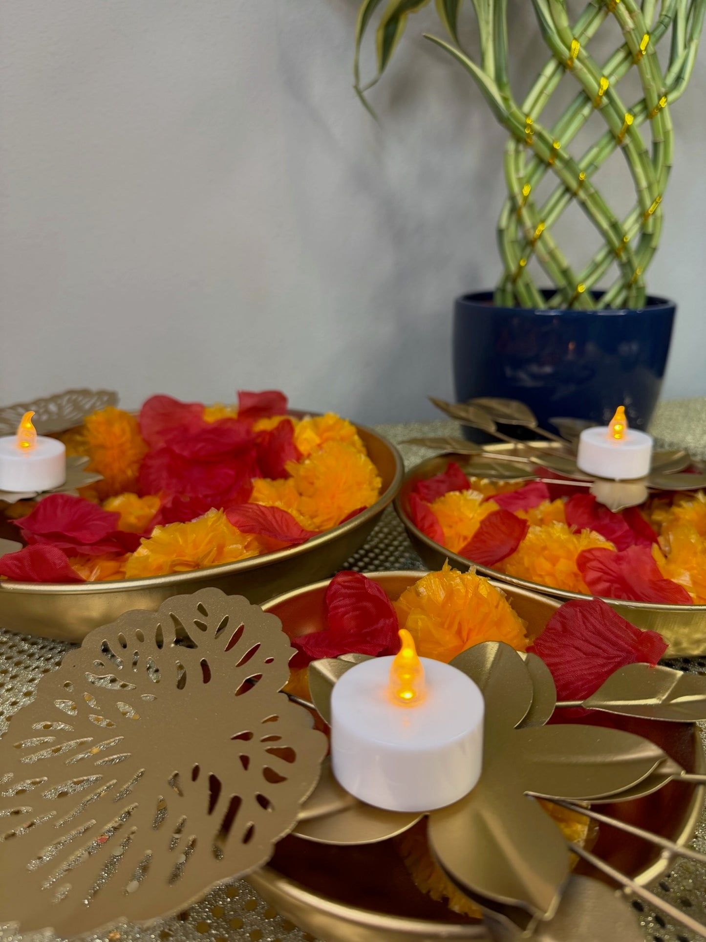 Leaf-shaped gold tealight holder with lit candle, Diwali decor