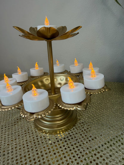 Gold pedestal diya stand with eight tealight cups, angled view