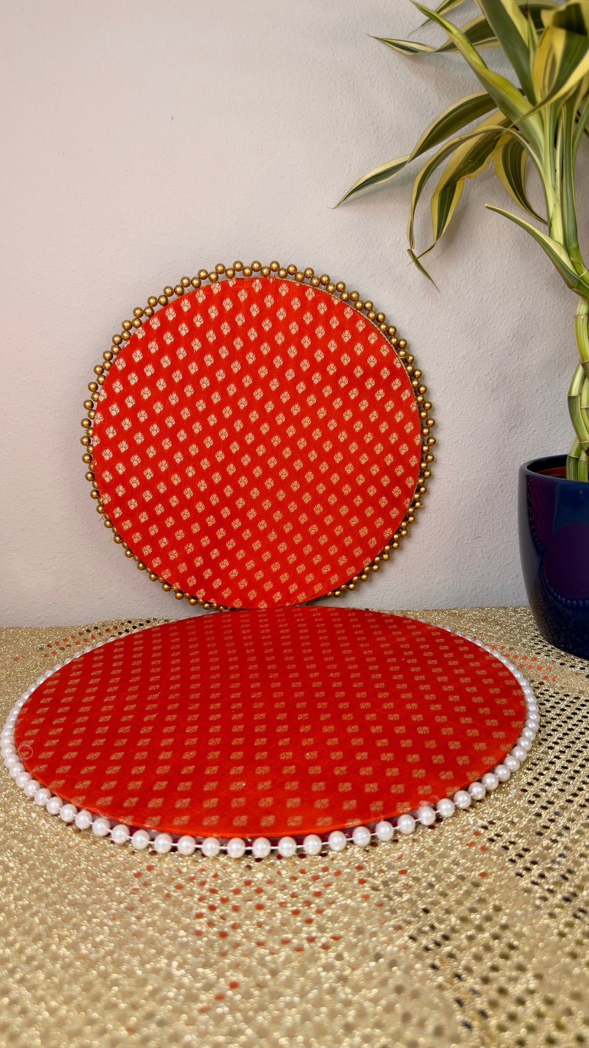 Red and gold brocade round puja thali with pearl-edged mat for Diwali and Karva Chauth