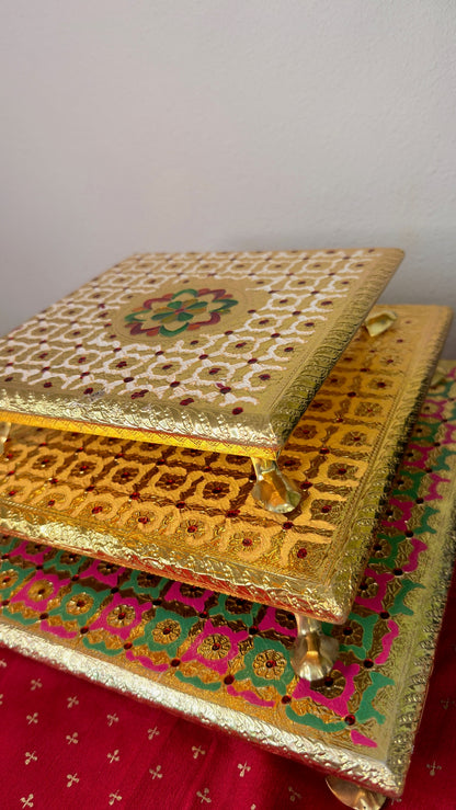 Set of three stackable brocade bajot chowkis, angled view