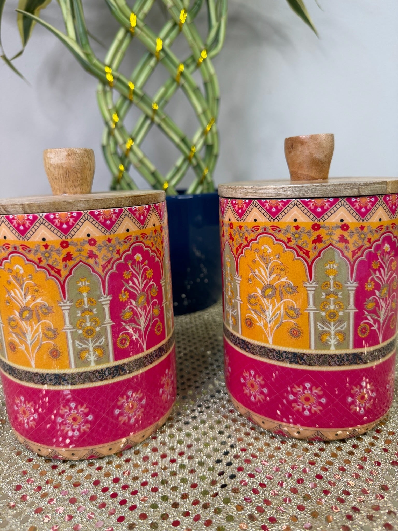 Pink and saffron Mughal print wooden storage canisters, front view
