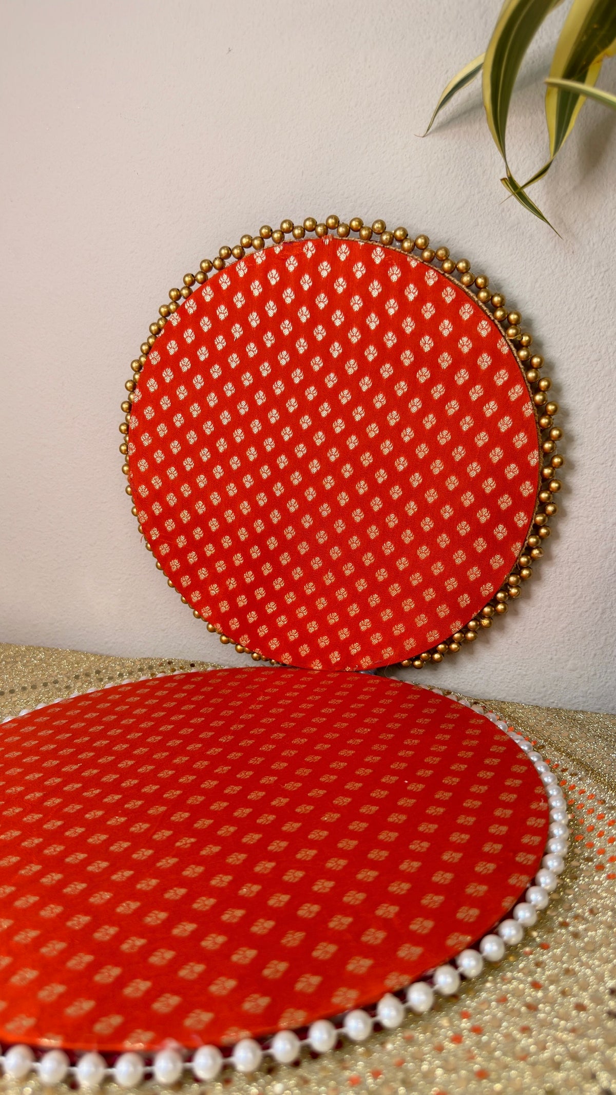 Red and gold brocade round thali showing gold bead rim and pearl mat detail