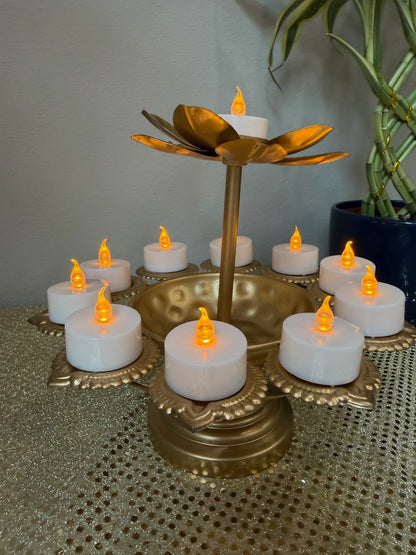 Two-tier gold lotus tealight stand styled with plant backdrop for Diwali decor