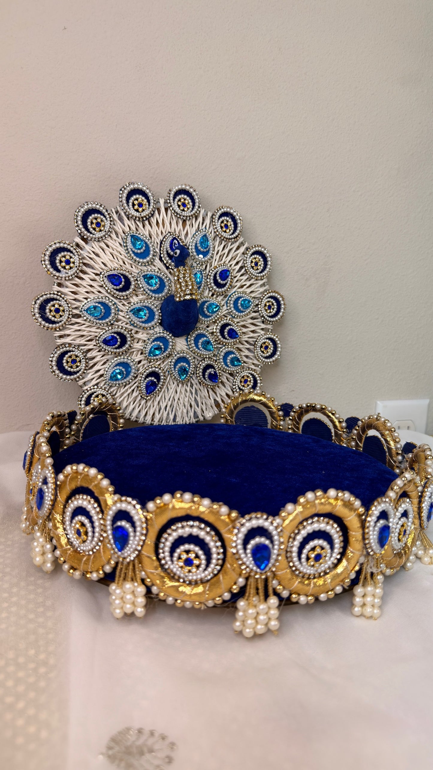 Royal blue velvet Laddu Gopal throne with pearl peacock, angled view