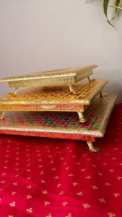 Stackable brocade puja chowki set in gold, maroon dot and pink green, 8 10 and 12 inch bajots