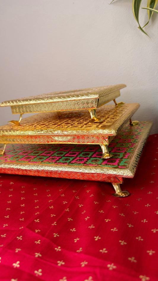 Stackable brocade puja chowki set in gold, maroon dot and pink green, 8 10 and 12 inch bajots