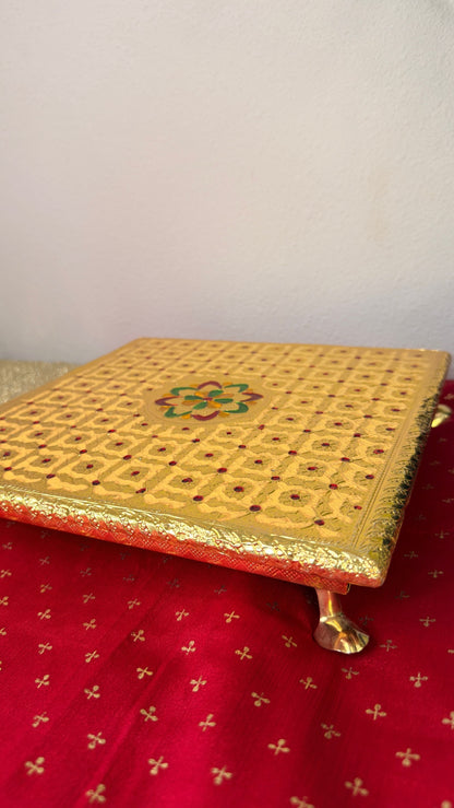 Side detail of gold brocade fabric on square puja chowki